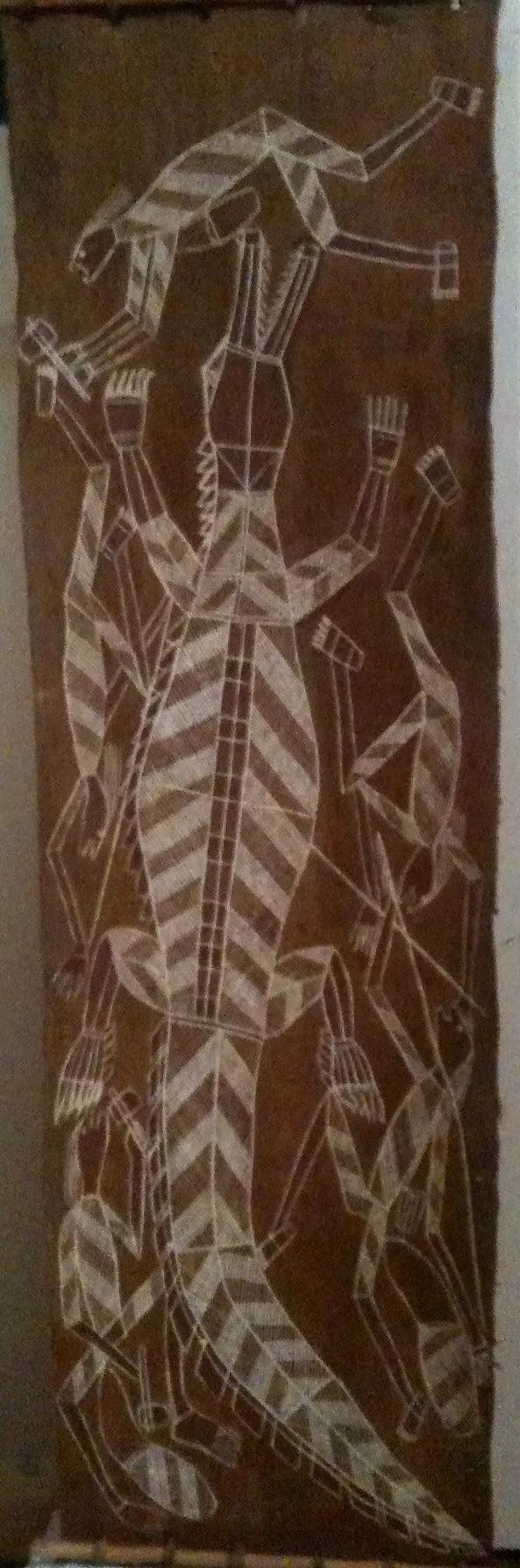 Billinyara  Nabegeyo, Mimihs hunting Freshwater Crocodile, 1993, natural earth pigments on bark, 36 x 124 cm