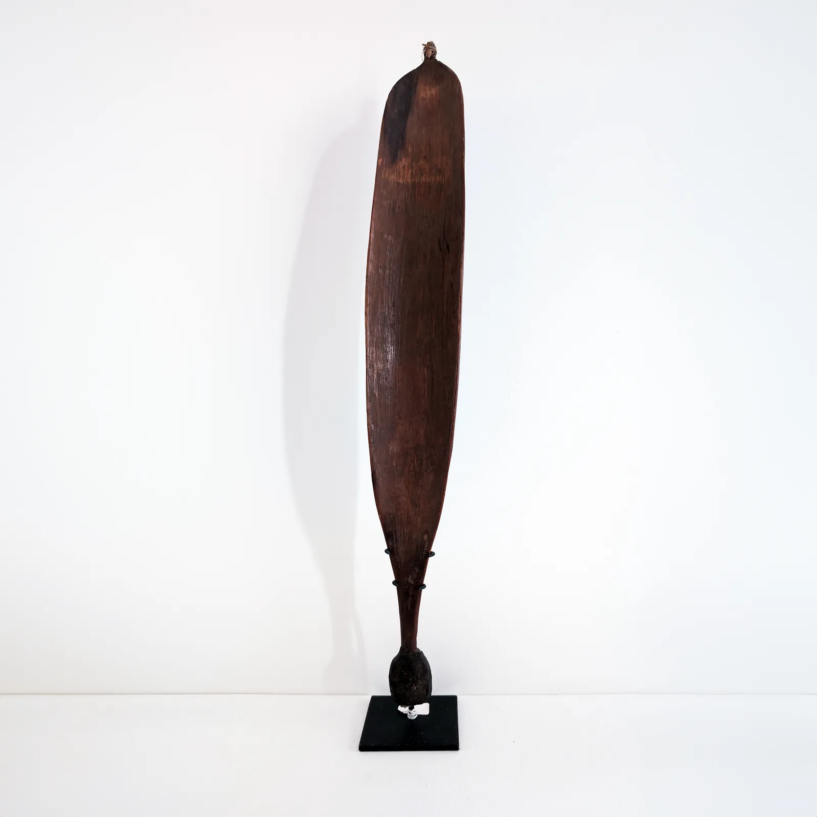 Artist Once Known, Central Australian Woomera, c. early 20th century, carved wood, 70h x 10w x 3d cm
