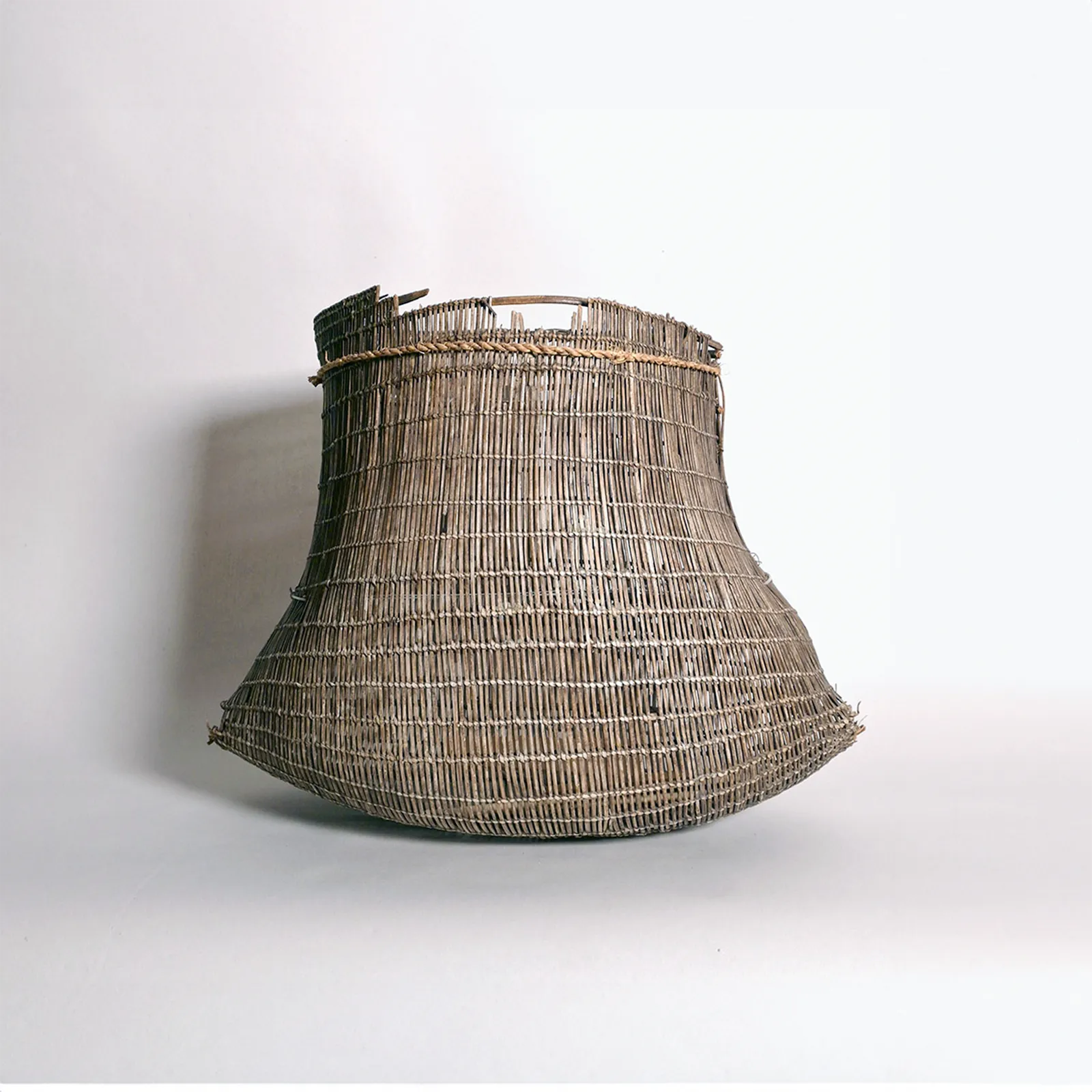 Artist Once Known, Fine Early Bicornual Basket (Jawun), Early 1900s, woven split lawyer cane, 23 x 30 x 17 cm
