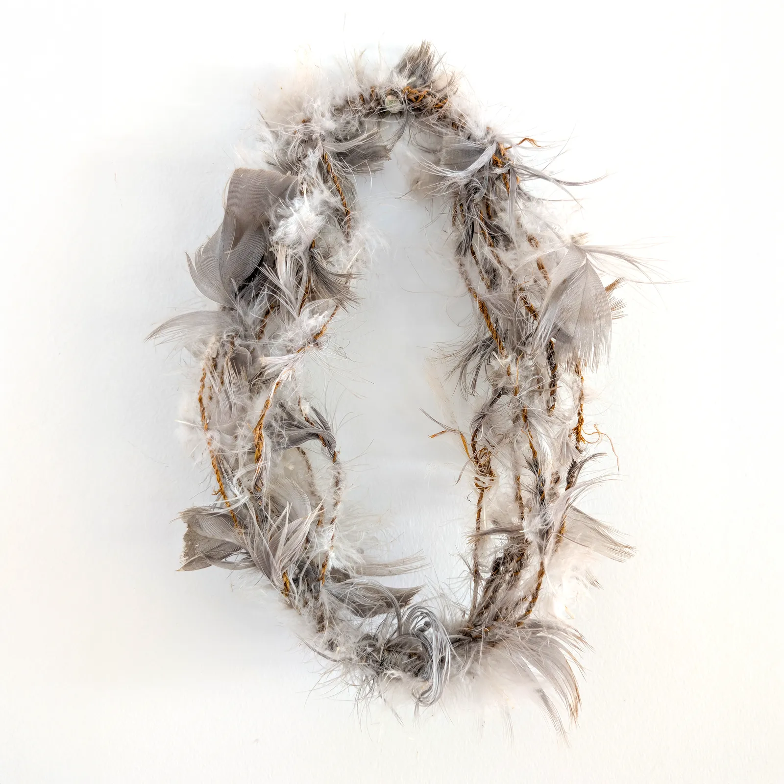 Rosalyn Guyula, Head Band, c.1985, feather and string, 28 cm diameter